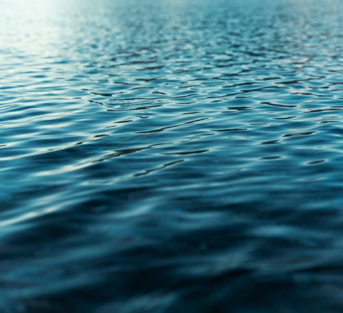 Free Close-up view of tranquil ocean waves at twilight, capturing the serene and calming essence of the sea. Stock Photo