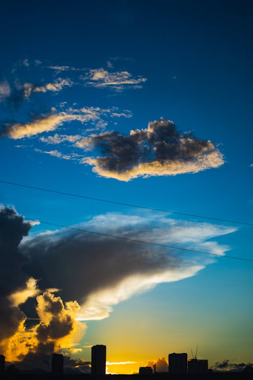 Photos gratuites de bâtiments, ciel bleu, coucher de soleil