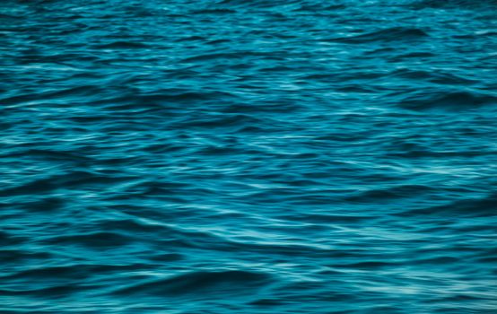 A close-up view of vibrant blue ocean waves, capturing the dynamic texture and movement.