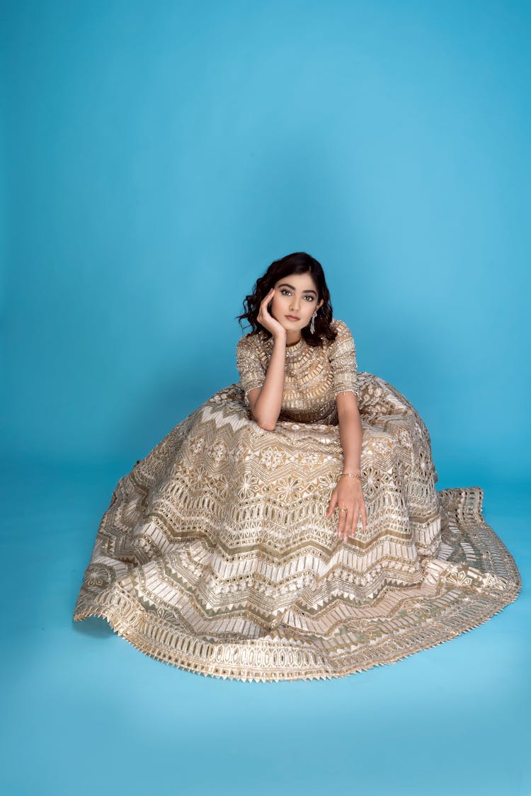 Female Fashion Model Posing In A Long White And Gold Dress