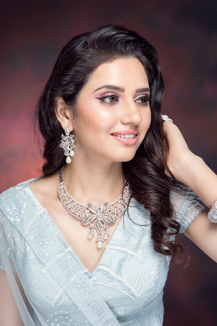 A Woman Wearing Necklace And Earrings