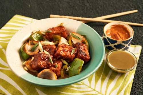 Free A vibrant bowl of stir-fried tofu with vegetables, garnished with green onions. Perfect for an appetizing meal. Stock Photo