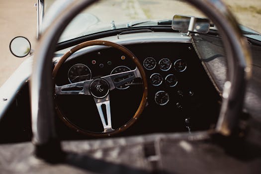 Close-up of a classic vintage car dashboard with wooden steering wheel.