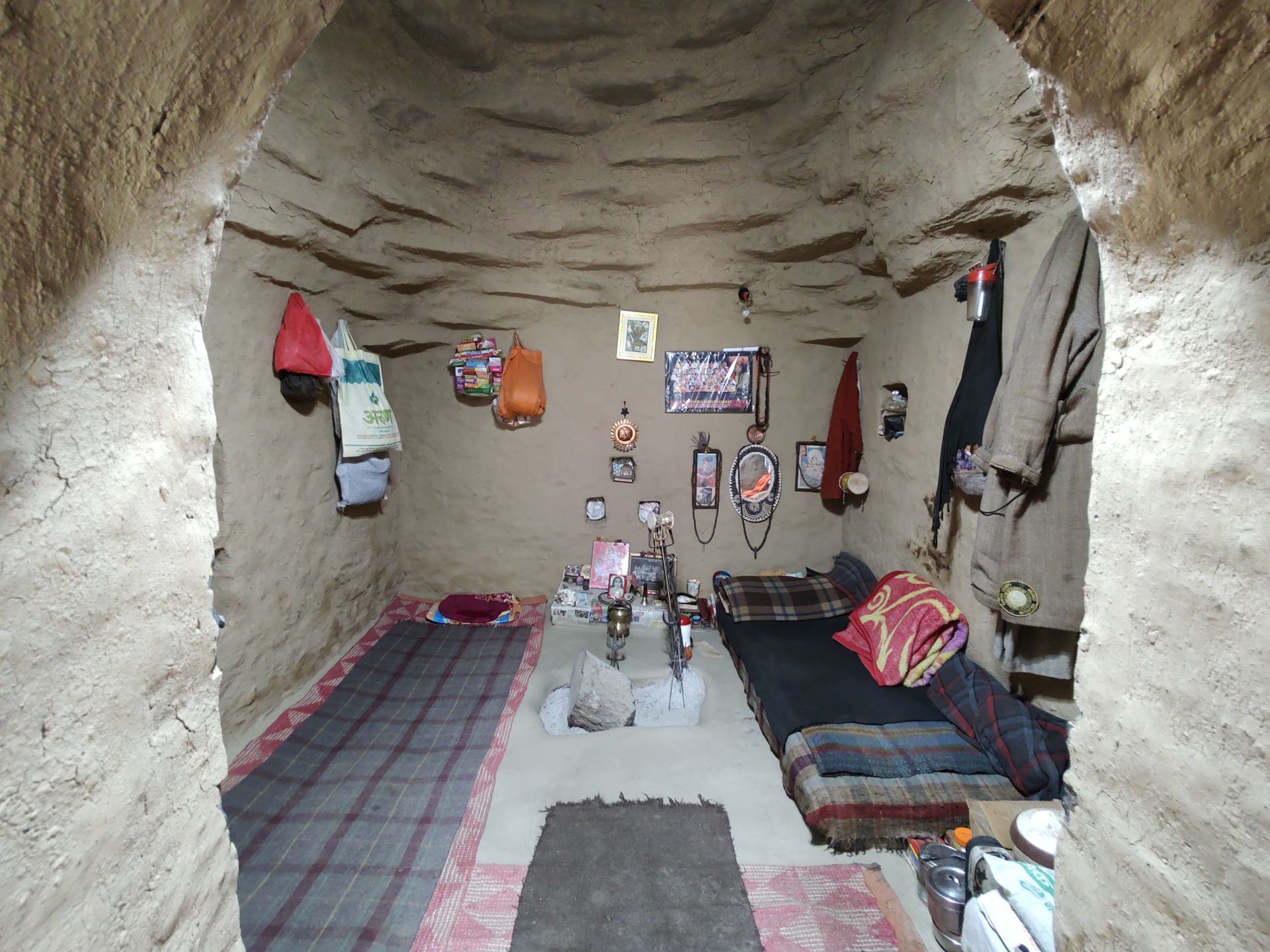 Cozy stone interior with bedding and decorations in Mirai Malli, India.
