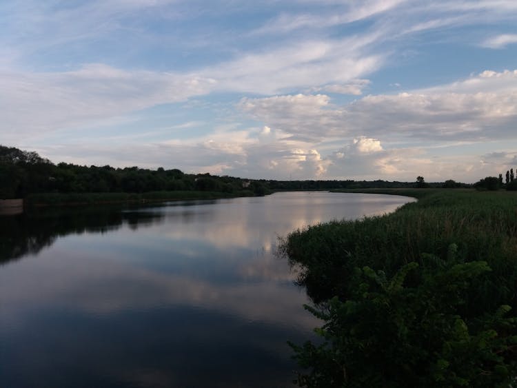 A Photo Of A River Under The Cloudy Sky