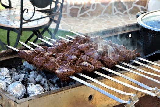 Savory skewers grilling on a charcoal barbecue, perfect for outdoor culinary delights.