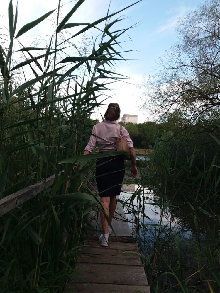 A Woman Walking On Wooden Bridge