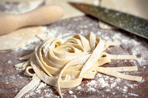Close-up of Raw Pasta and Flour on a Table 