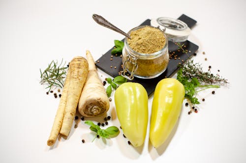 Close-up of Fresh Vegetables and a Jar with Powdered Spices 