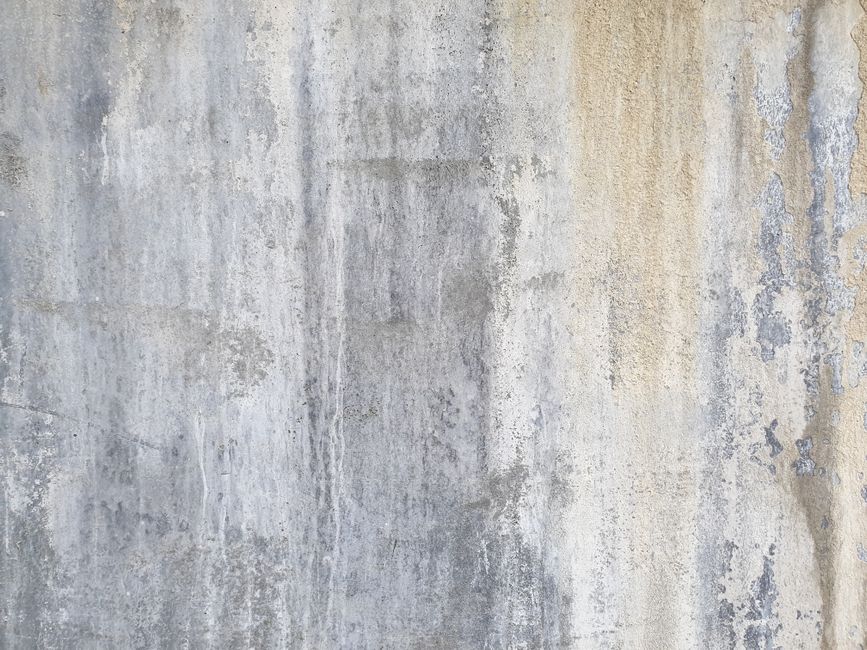 High-resolution image of a rustic gray stone wall with textured pattern.