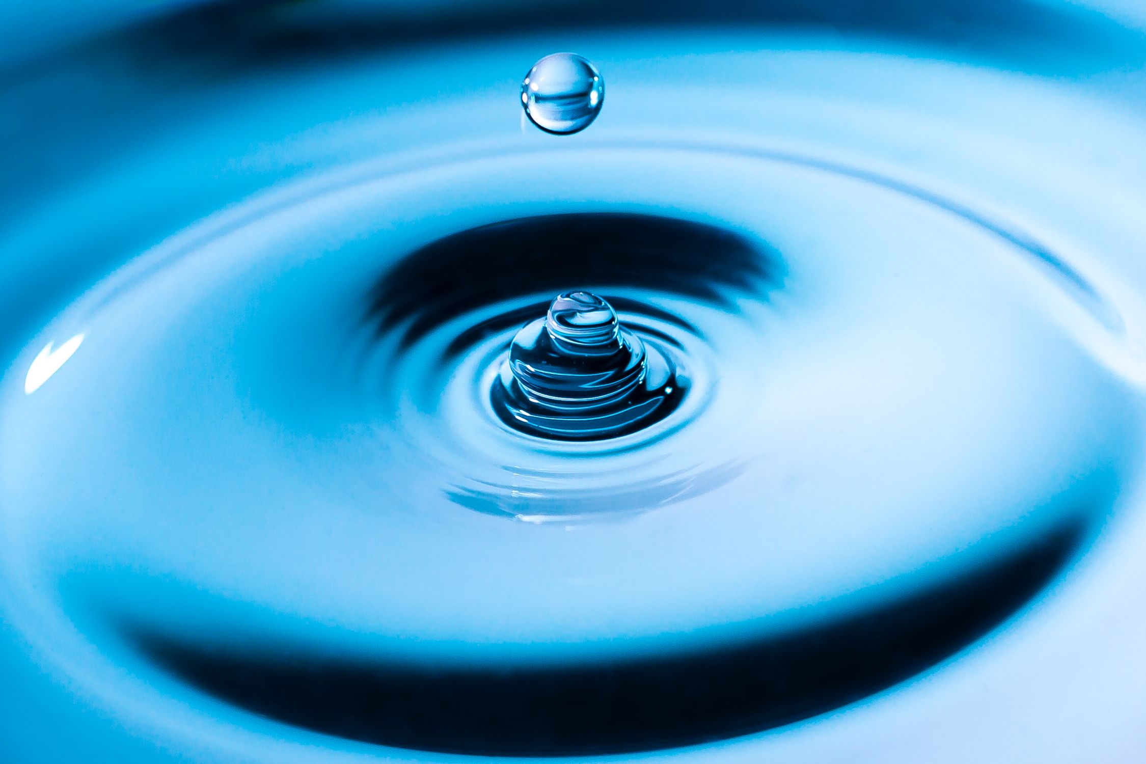 Close-up of a Water Droplet Falling into the Water · Free Stock Photo