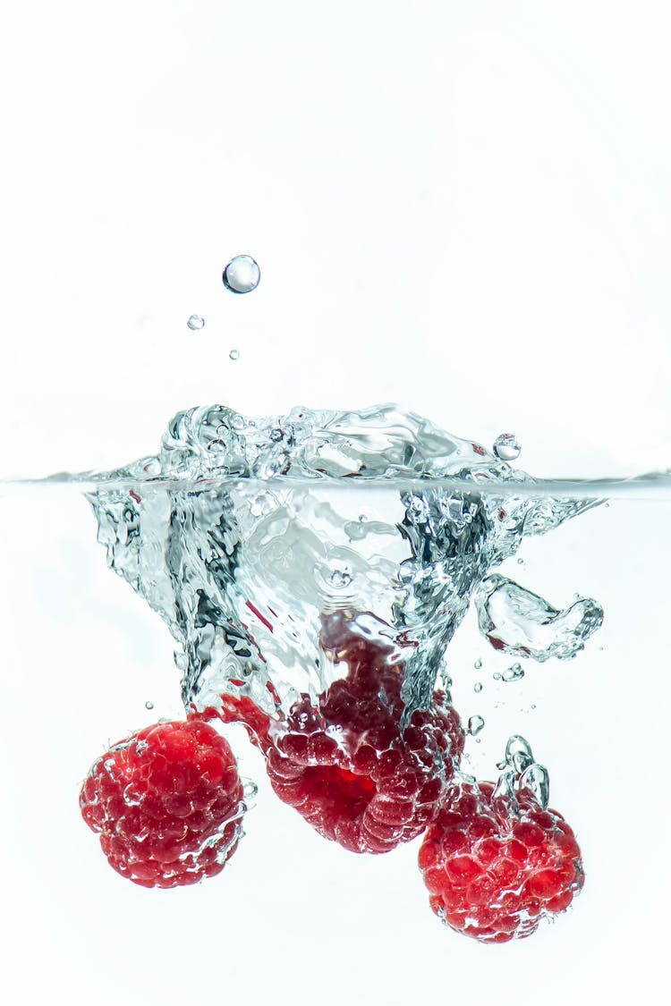 Raspberries Falling Into The Water