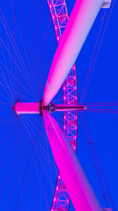 Low Angle Shot of a Ferris Wheel Under the Blue Sky 