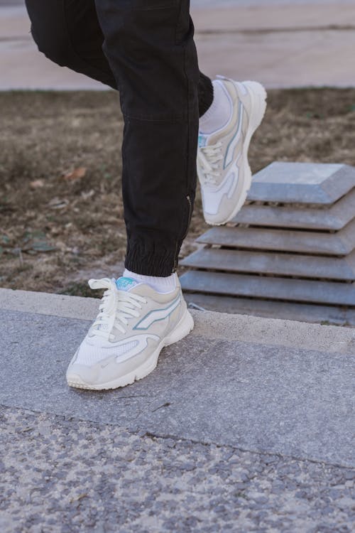 A Person Wearing White Sneaker Shoes