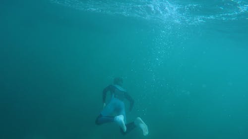 Free Person Diving Under Body of Water Stock Photo