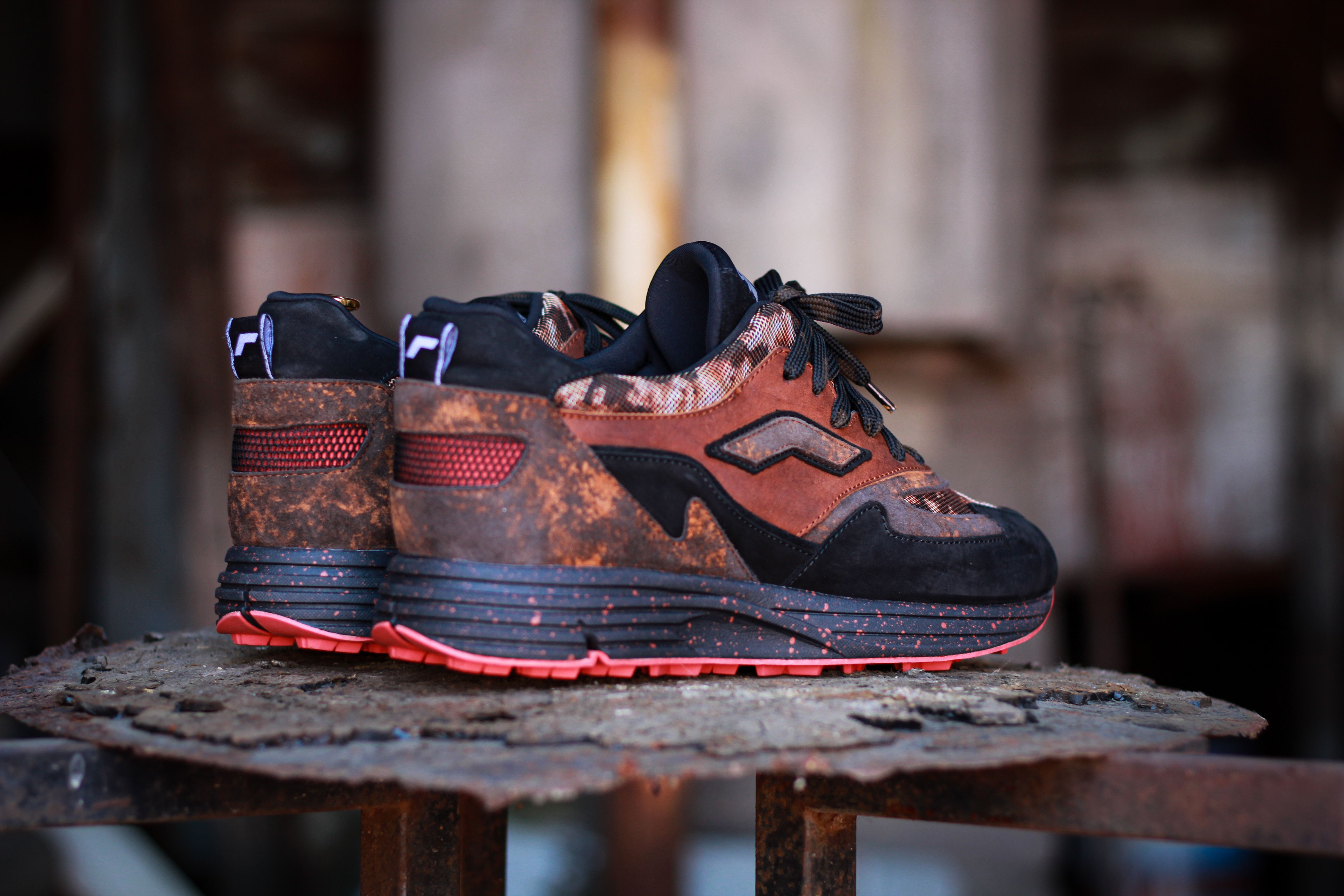 Brown suede sneakers on a wooden surface
