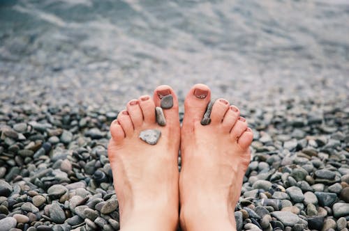 Free Stones on Woman's Feet Stock Photo