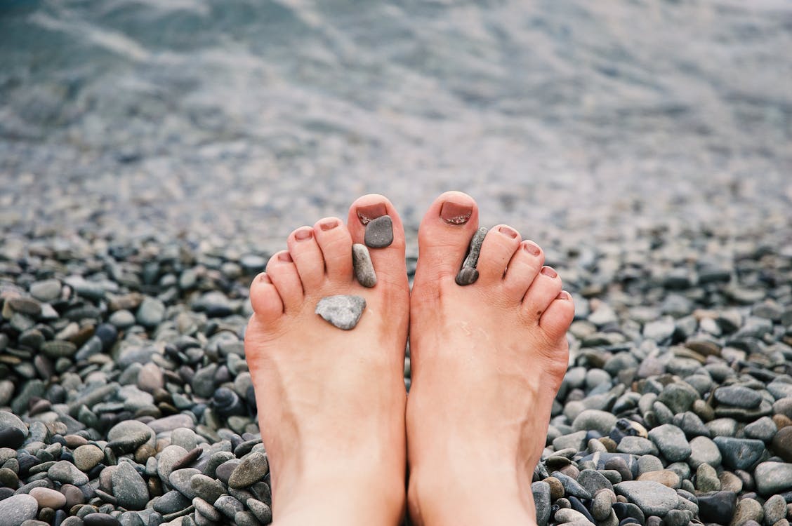Free Stones on Woman's Feet Stock Photo