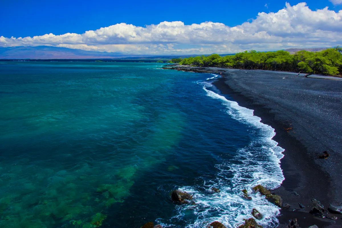 Aerial view of a black-sand beach on the Big Island of Hawaii