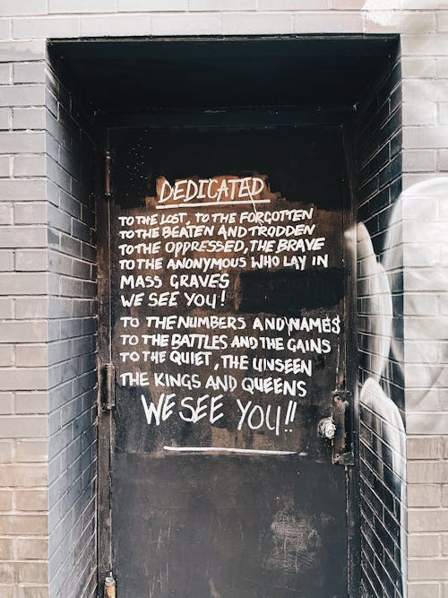 Old Black Door with a Text Written on Them 