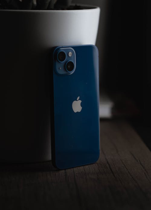 Free Apple Blue iPhone 13 on Wooden Surface  Stock Photo