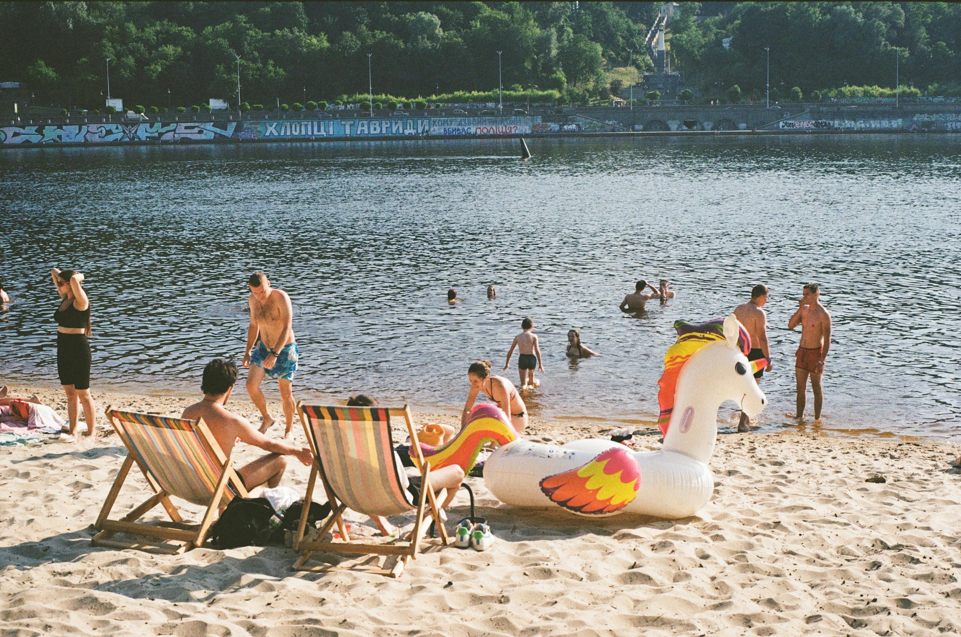 people enjoying the sandy shores of Madison Park Beach - buy a condo in madison park wa