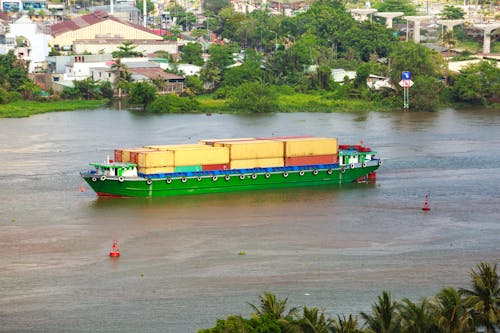 Container Ship on River in Town