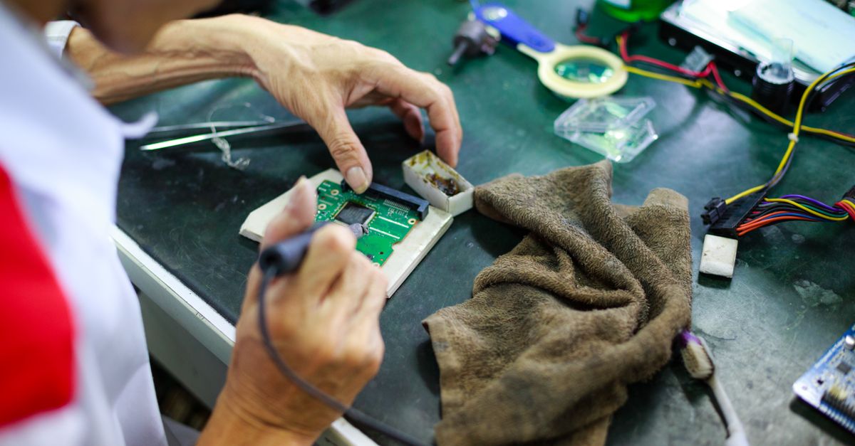 Hands of a Technician Repairing an Electronic Component · Free Stock Photo