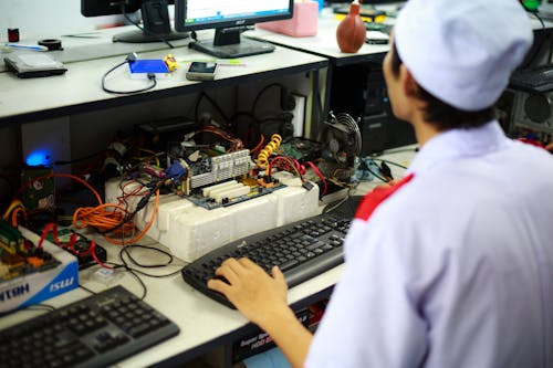 Man Typing on Keyboard in Laboratory