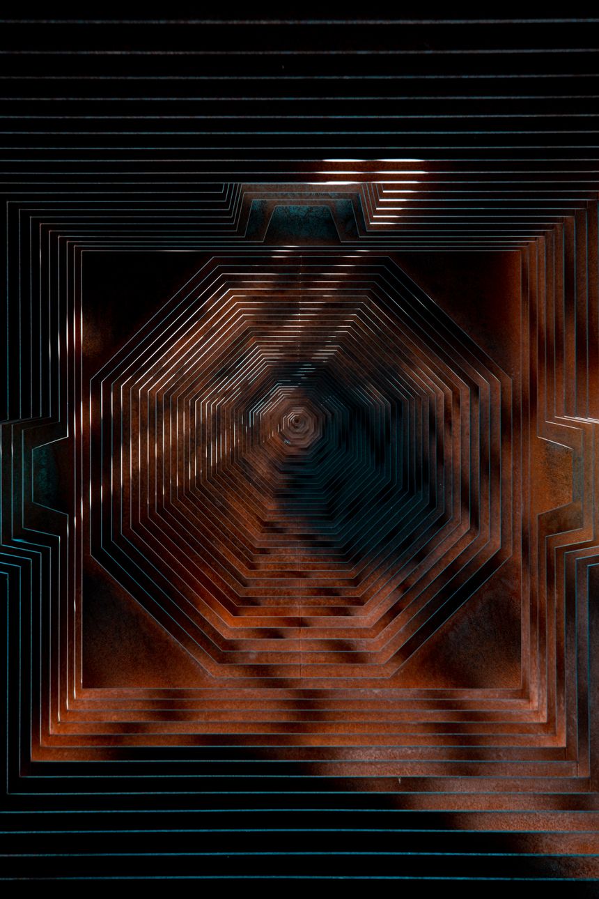 Concentric copper-lit ridges receding into a dark geometric tunnel &mdash; Laura Paredis on Pexels