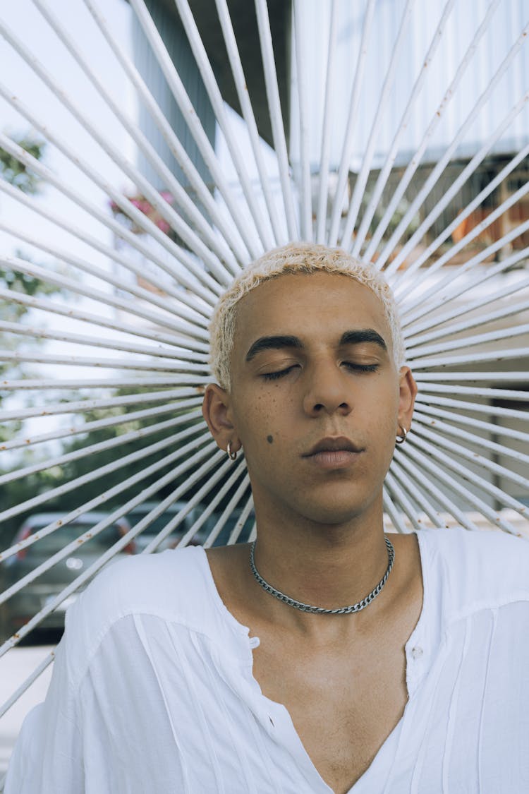 Portrait Of Man With Bleached Hair And Headpiece 