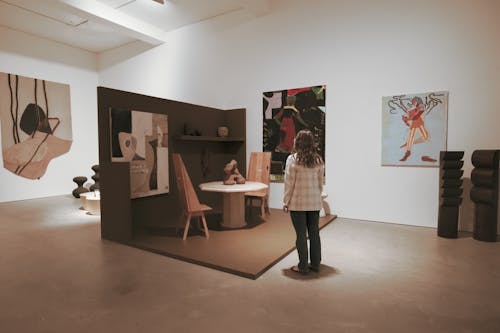Back View of Woman Standing inside an Art Gallery