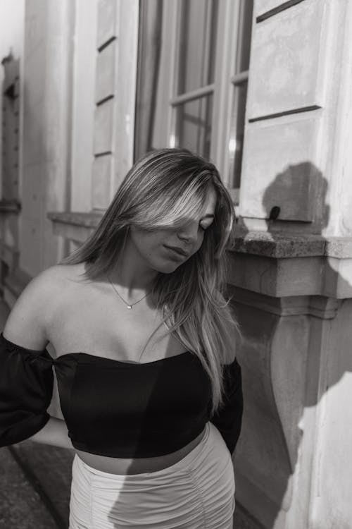 Woman Posing near Building in Black and White