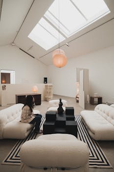 Elegant modern living room in London featuring chic decor, plush sofas, and large skylights.