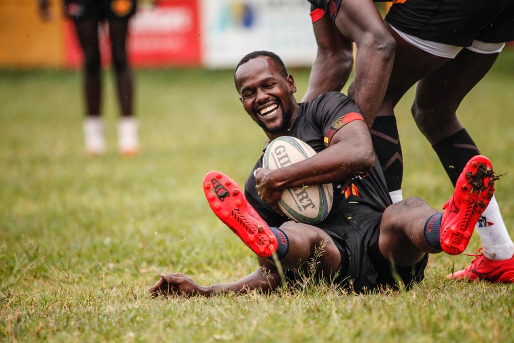 Kingsfold player sliding across the turf with the ball
