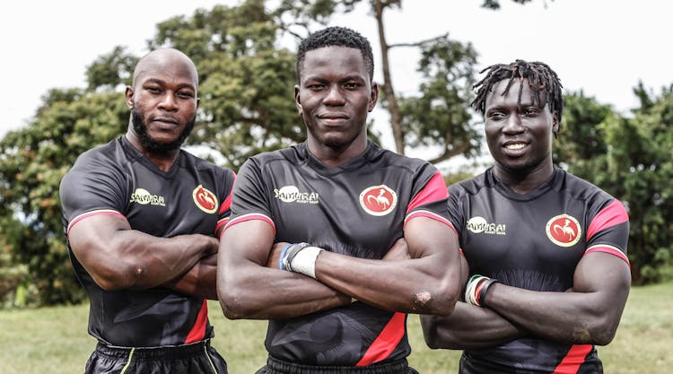 Athletes In Black Uniform Smiling At The Camera