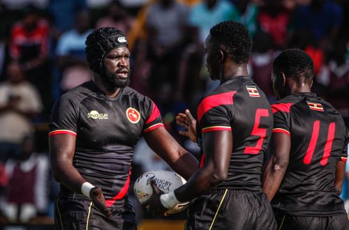 Free Dynamic shot of rugby players discussing strategy on the field. Stock Photo