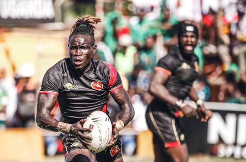 Men in Black Uniform Playing Rugby