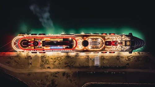 Top View of an Illuminated Cruise Ship in a Dock at Night 