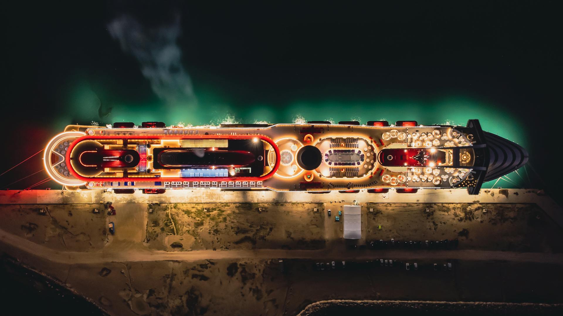 Top View of an Illuminated Cruise Ship in a Dock at Night