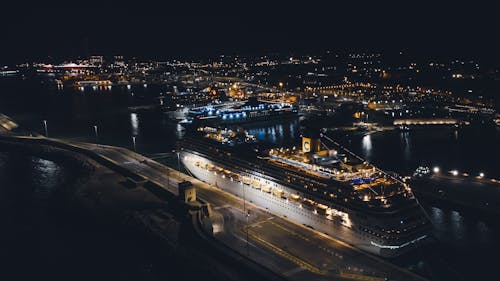 Aerial View of Cityscape with Cruise Ship on Dock during Nigh Time