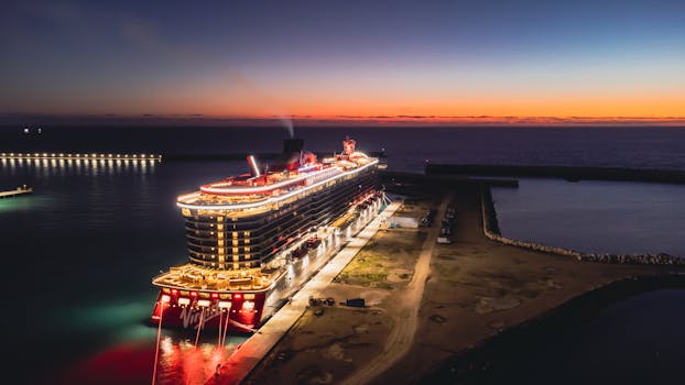 Stunning aerial view of a cruise ship docked at Civitavecchia harbor during sunset, Italy.