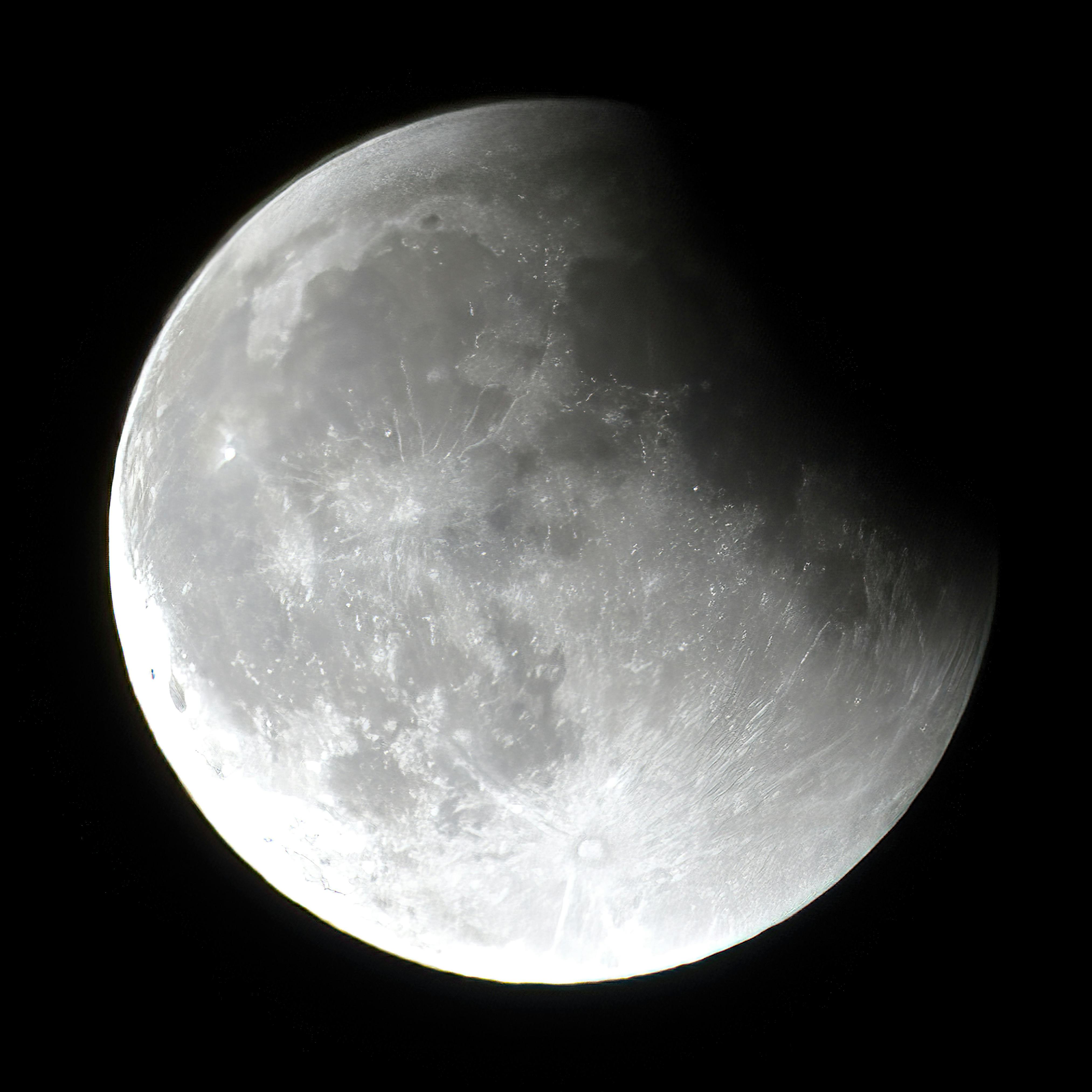 A striking black and white image capturing the detailed surface of the moon.