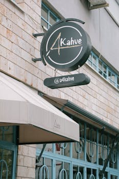 Stylish sign of a coffee shop on a urban building exterior promoting cafe culture.