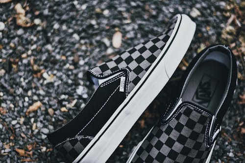 Free Gray and Black Checkered Slip-on Shoes on Ground Stock Photo