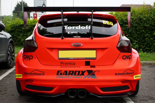 Rear view of a red Ford Focus RS with a spoiler, parked in Whitstable, England.