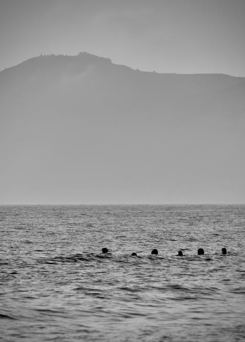 Monochrome Photo of People on Ocean