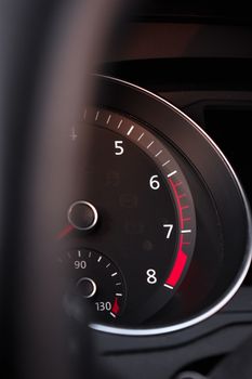Detailed view of a car tachometer displaying RPM in a vehicle interior.