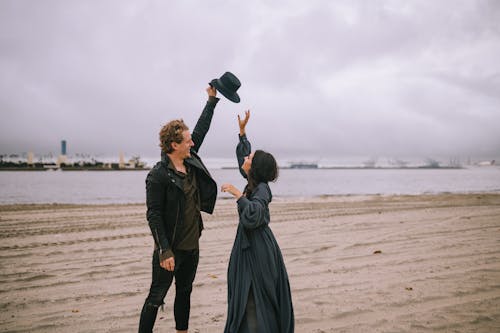 A Couple Playing on the Beach Together 