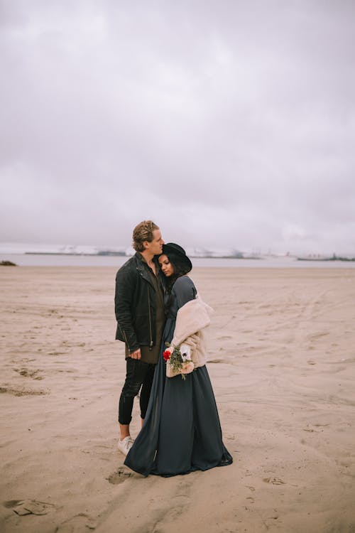 A Couple Standing on the Beach Shore